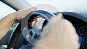 Young beautiful hispanic woman driving a car on the road