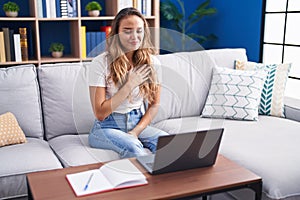 Young beautiful hispanic woman having video call communicate with sign deaf language at home