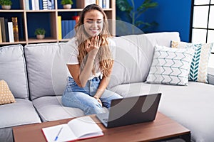 Young beautiful hispanic woman having video call communicate with sign deaf language at home