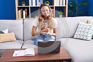 Young beautiful hispanic woman having video call communicate with sign deaf language at home