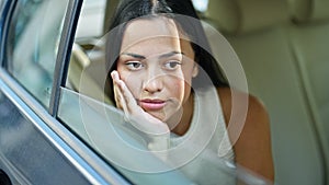 Young beautiful hispanic woman passenger sitting on car with relaxed face at park