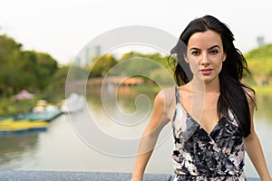 Young beautiful Hispanic woman relaxing in the park