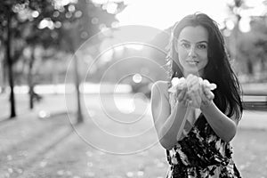 Young beautiful Hispanic woman relaxing in the park