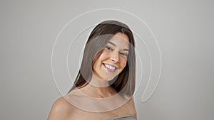 Young beautiful hispanic woman smiling confident combing hair with hands over isolated white background