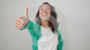 Young beautiful hispanic woman smiling confident doing ok sign with thumb up over isolated white background