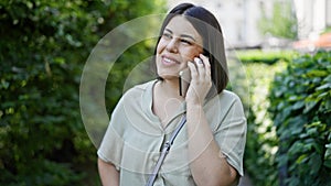 Young beautiful hispanic woman smiling happy speaking on the phone at the park in Vienna