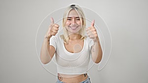 Young beautiful hispanic woman smiling with thumbs up over isolated white background