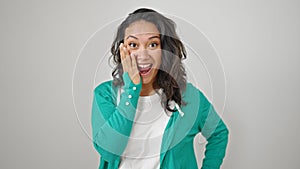 Young beautiful hispanic woman standing with surprise expression over isolated white background