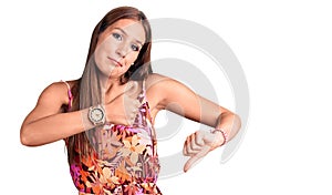 Young beautiful hispanic woman wearing casual clothes doing thumbs up and down, disagreement and agreement expression