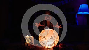 Young beautiful hispanic woman wearing katrina costume doing incantation at home