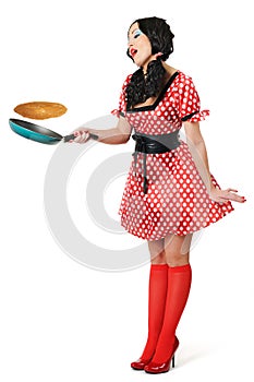 Young beautiful housewife with frying pan