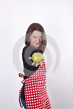 Young beautiful housewife holding apple