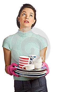 Young beautiful housewife with pile of dishes