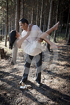 Young beautiful Indian couple dancing in forest