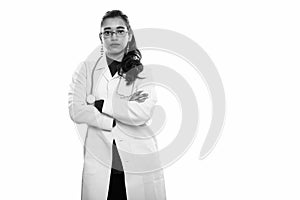 Young beautiful Indian woman doctor standing with arms crossed