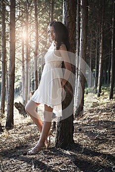 Young beautiful Indian woman in forest wearing white