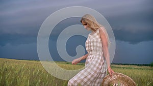 Young beautiful inspired girl is walking in field n rainy day, freedom concept