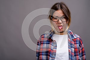 Young beautiful Kazakh woman against gray background