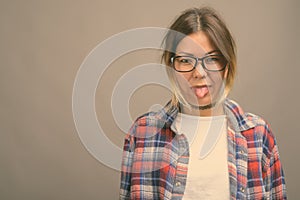 Young beautiful Kazakh woman against gray background