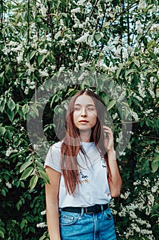 Young beautiful lady surrounded by cherry bird in spring