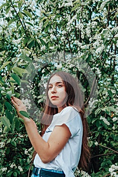 Young beautiful lady surrounded by cherry bird in spring