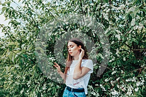 Young beautiful lady surrounded by cherry bird in spring