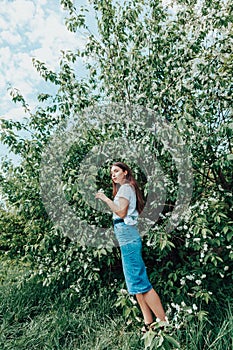 Young beautiful lady surrounded by cherry bird in spring