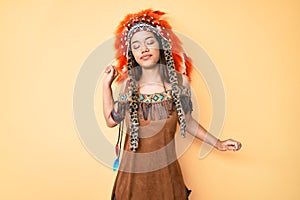 Young beautiful latin girl wearing indian costume stretching back, tired and relaxed, sleepy and yawning for early morning