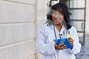 Young beautiful latin woman doctor smiling confident using touchpad at hospital