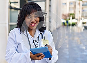 Young beautiful latin woman doctor smiling confident using touchpad at hospital