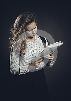 Young beautiful longhaired college girl with papers