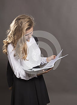 Young beautiful longhaired college girl with papers