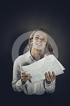 Young beautiful longhaired student girl with papers looks happy