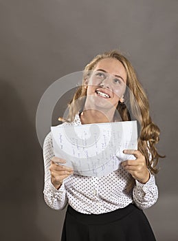 Young beautiful longhaired student girl with papers looks happy