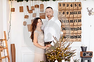 Young beautiful man and woman are celebrating Christmas. A loving couple enjoy each other on New Year`s Eve