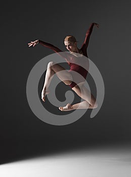 Young beautiful modern style dancer jumping on a
