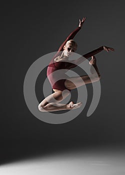 Young beautiful modern style dancer jumping on a