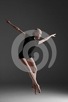 Young beautiful modern style dancer jumping on a