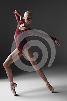 Young beautiful modern style dancer posing on a