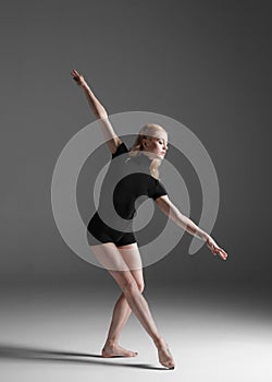 Young beautiful modern style dancer posing on a