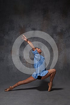 Young beautiful modern style dancer posing on a