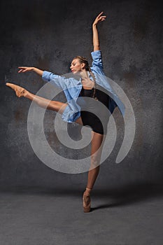 Young beautiful modern style dancer posing on a