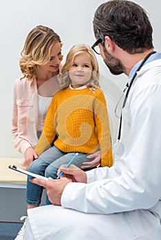 young beautiful mother and daughter visiting pediatrist