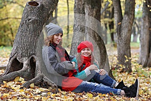 Young beautiful mother with her daughter on nature. A girl in a