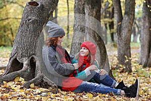 Young beautiful mother with her daughter on nature. A girl in a