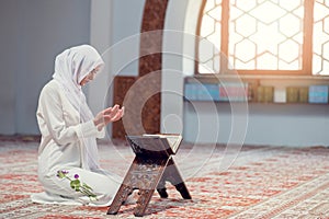 Young beautiful Muslim Woman Praying In Mosque