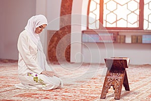 Young beautiful Muslim Woman Praying In Mosque