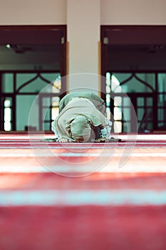 Young beautiful Muslim Woman Praying In Mosque