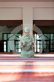 Young beautiful Muslim Woman Praying In Mosque