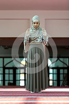 Young beautiful Muslim Woman Praying In Mosque